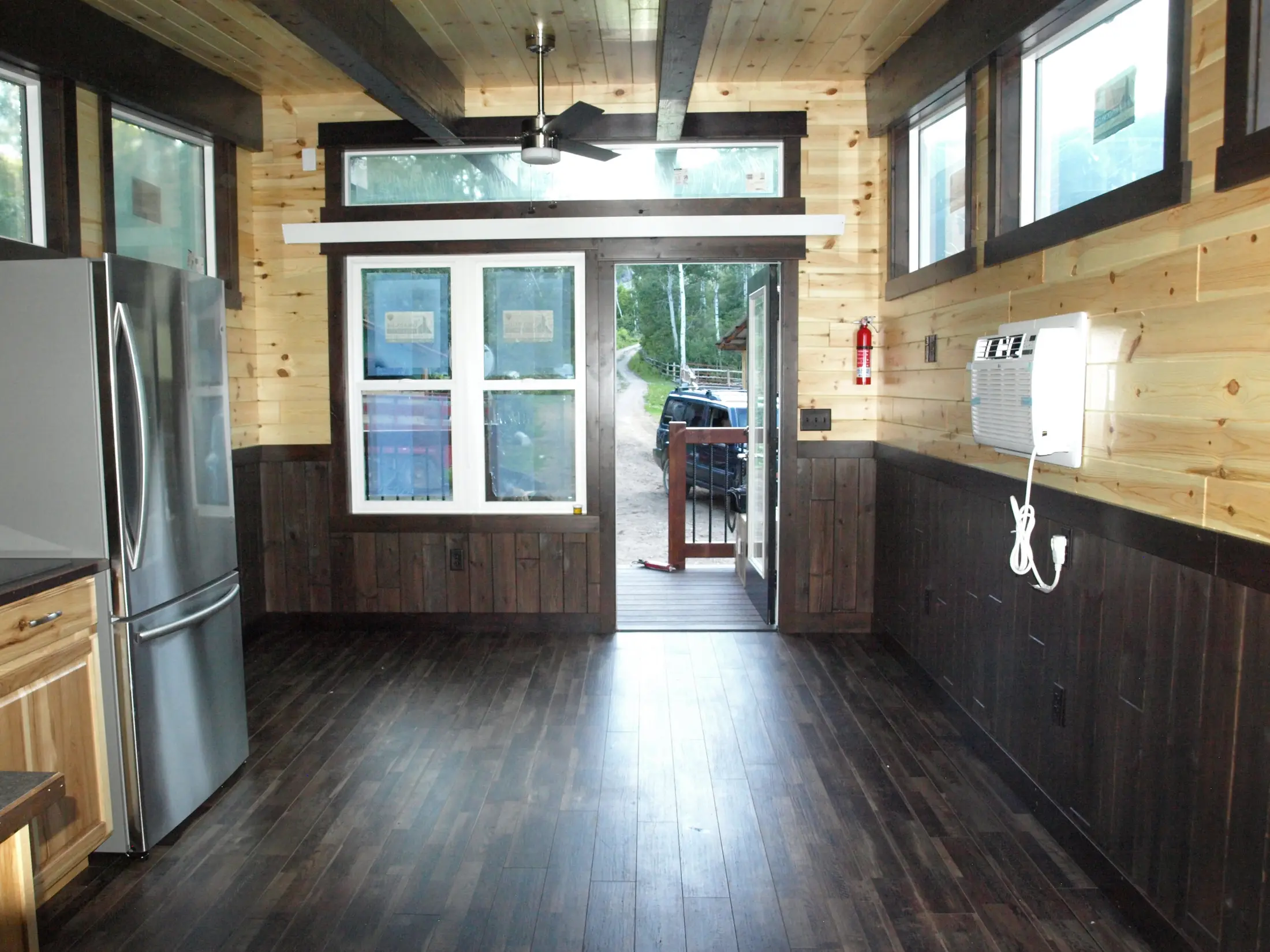 Two-tone knotty pine interior of a Buffalo River build with kitchenette